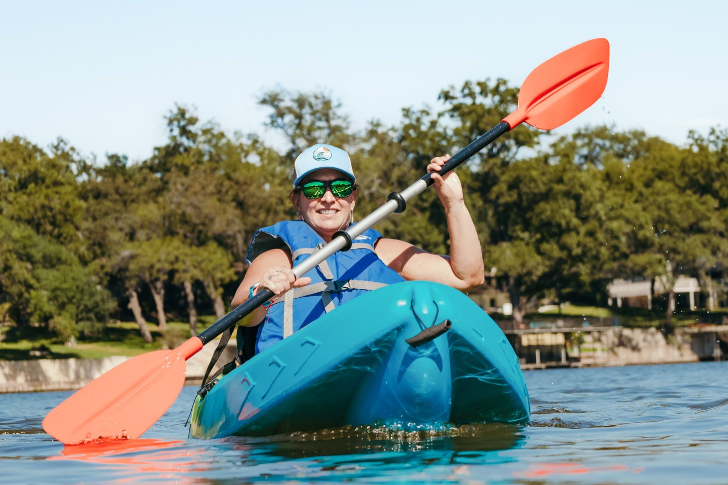 Person kayaking on a lake in Central Texas with a rental from WaterTied Outfitters